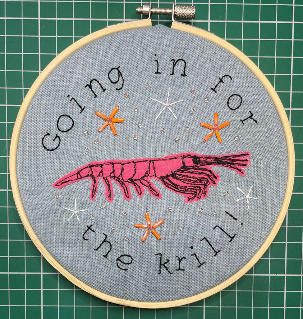 pink embroidered krill surrounded by beaded brittle stars with text Going In for the Krill
